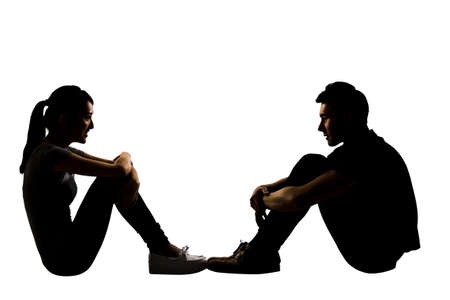 Young couple face to face sit on ground, full length portrait isolated on white.