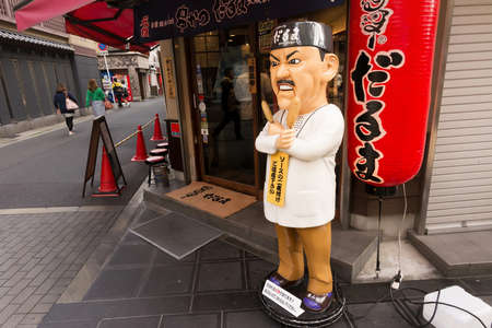 OSAKA, JAPAN - APRIL 18th  :Interestingly human form statue in front of the restaurant, Osaka, Japan on 18th April 2014.のeditorial素材