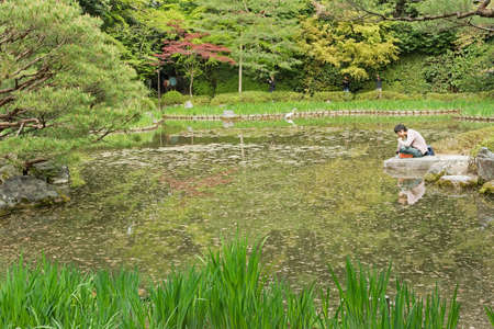 KYOTO, JAPAN - APRIL 19th : The scenery of the pond in Japanese gardening. near Heian Shrine, Kyoto,  Japan. on 19th April 2014.のeditorial素材