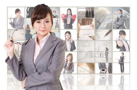 Attractive Asian business woman standing in front of TV screen wall, closeup portrait.の写真素材