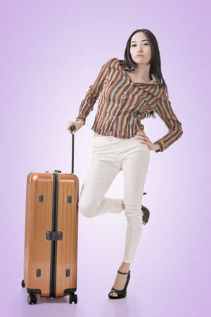 Modern Asian woman stand with a luggage in vintage style.の写真素材