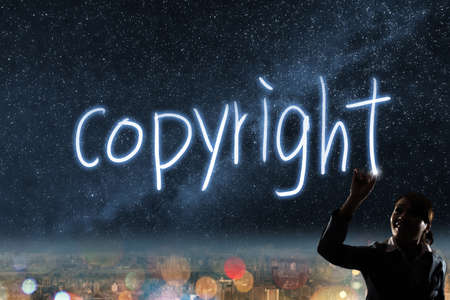 Concept of copyright, silhouette asian business woman light drawing.の写真素材