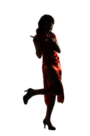 Silhouette of Chinese woman dress traditional cheongsam at New Year, studio shot isolated on white background.の写真素材
