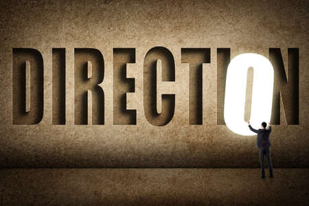 Concept of target, choice, decisioin etc with asian business man and 3D text on wall.の写真素材