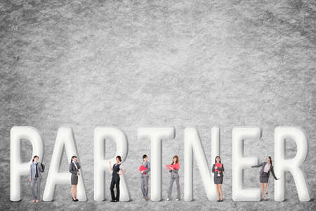 Concept of partner, friends,collaborate with group of business people stand with 3d text.の写真素材