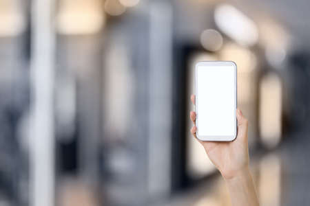 Using smartphone in a market or department store, closeup image.の写真素材