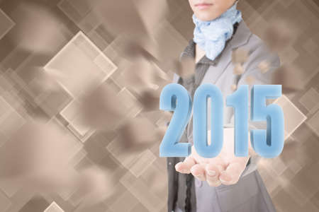 Concept of 2015, business woman holding a 3d text.の写真素材