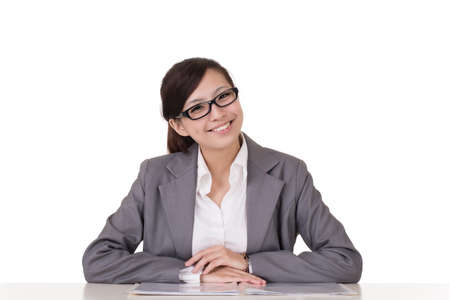 Smiling business woman of Asian sitting on chair against white background.の写真素材