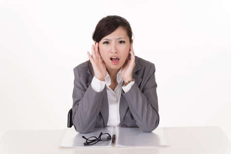 Worried business woman of Asian, closeup portrait on white background.の写真素材