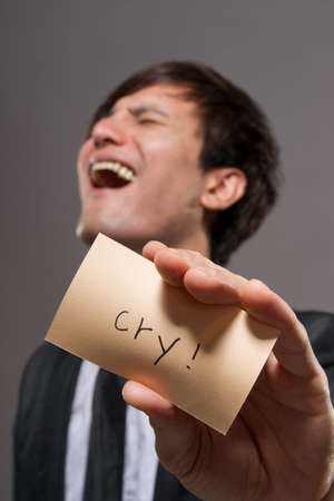 Asian businessman holding card in studio.の写真素材