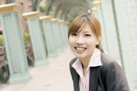Attractive young business woman look at you, shot at Xinyi business district, Taipei, Taiwan.の写真素材