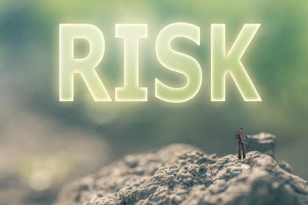 Concept of risk with a person stand in the outdoor and looking up the text over the sky in nature background.の写真素材