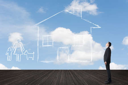 Asian man look toward the drawing house and family in the heaven.の写真素材