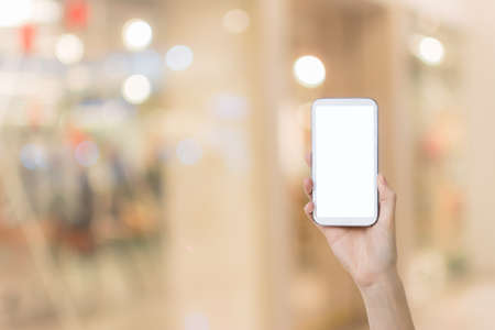 Using smartphone in a market or department store, closeup image.の写真素材