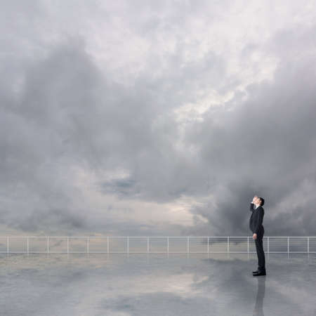 Man look and discover against the cloudy sky with copyspace.の写真素材