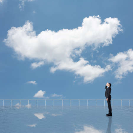 Man look and discover against the cloudy sky with copyspace.の写真素材