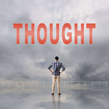 Concept of abstract concept with text on the sky and one man look at it.の写真素材