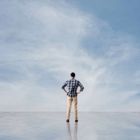 Man look and discover against the cloudy sky with copyspace.の写真素材