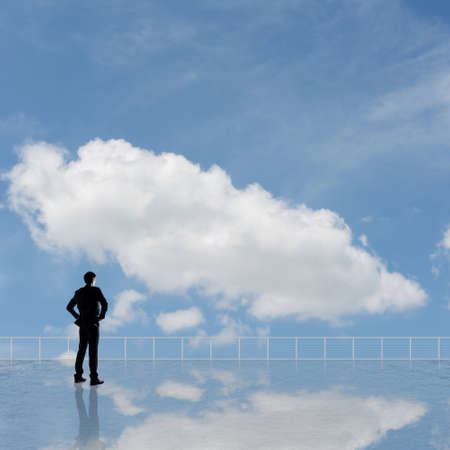 Man look and discover against the cloudy sky with copyspace.の写真素材