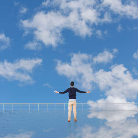 Man look and discover against the cloudy sky with copyspace.の写真素材