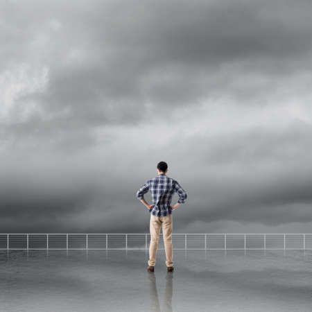 Man look and discover against the cloudy sky with copyspace.の写真素材