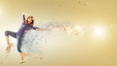 Excited Asian woman dancing with copyspace.の写真素材