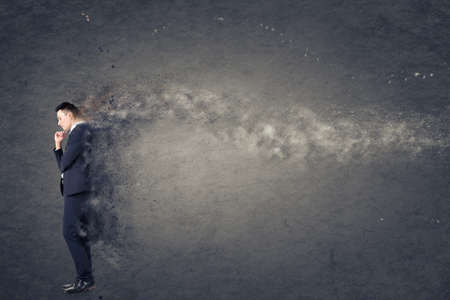 Confused young business man standing and thinking.の写真素材