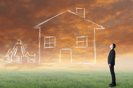 Asian man look toward the drawing house and family in the heaven.の写真素材