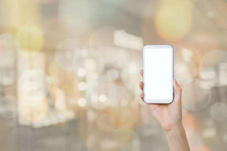 Using smartphone in a market or department store, closeup image.の写真素材