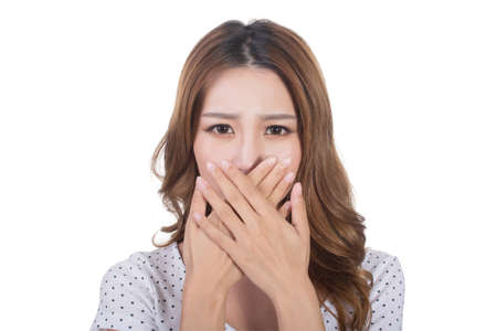 Portrait of a young woman holding her nose because of a bad smell.の写真素材