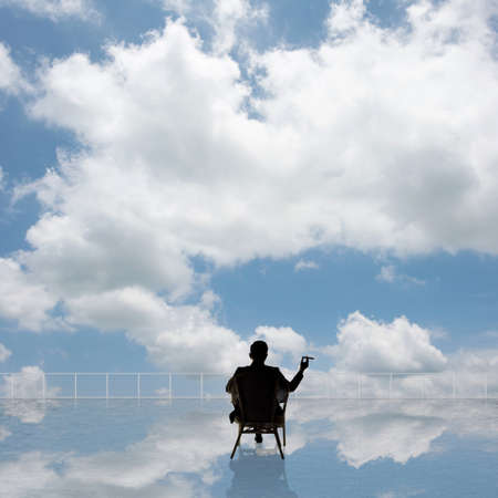 Man look and discover against the cloudy sky with copyspace.の写真素材