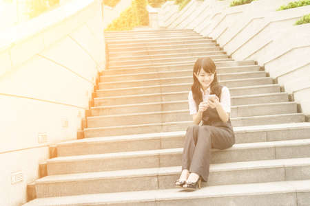 Business woman use smartphone in outside of modern city.の写真素材
