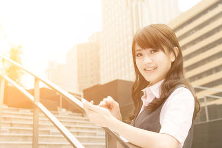 Business woman use smartphone in outside of modern city.の写真素材