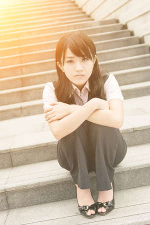 Sad business woman feel worried and stressed in outside of modern city.の写真素材