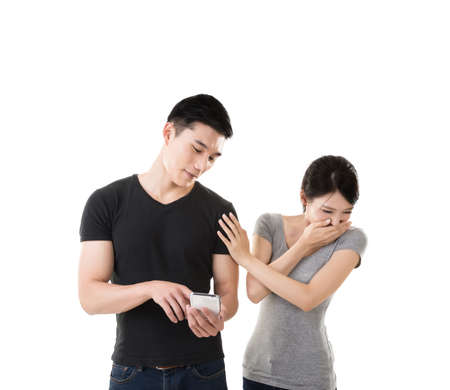 Asian young couple using cellphone, closeup portrait.の写真素材