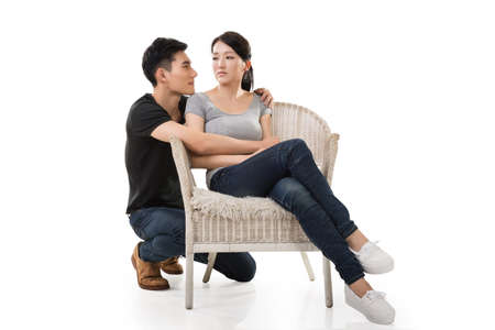 unhappy Asian young couple sit on sofaの写真素材