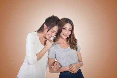 Asian woman with her friend, studio shot portrait.の写真素材
