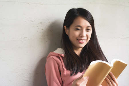 Asian beautiful woman read a book at home.の写真素材
