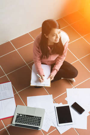 Asian woman working at home.