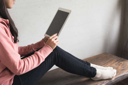 Asian girl use pad at home, concept of technology, working, internet etc.の写真素材