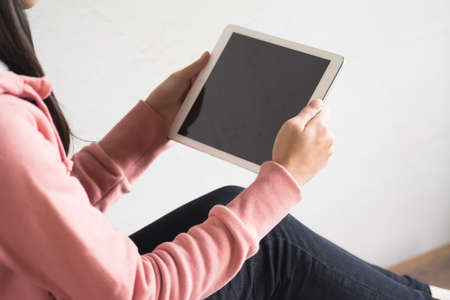 Asian girl use pad at home, concept of technology, working, internet etc.