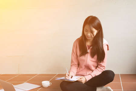 Asian woman working at home.の写真素材