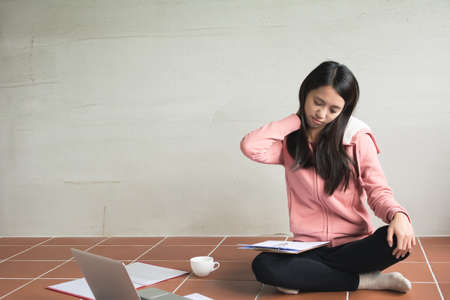 Asian woman working at home and feel tired.