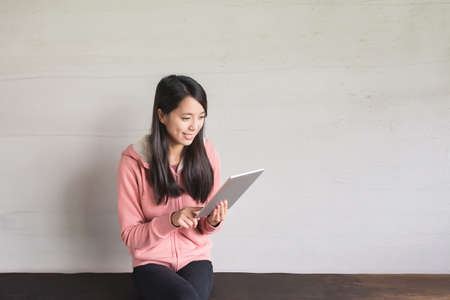 Asian girl use pad at home, concept of technology, working, internet etc.の写真素材