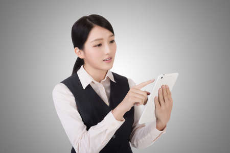 asian young business woman using pad, closeup portraitの写真素材