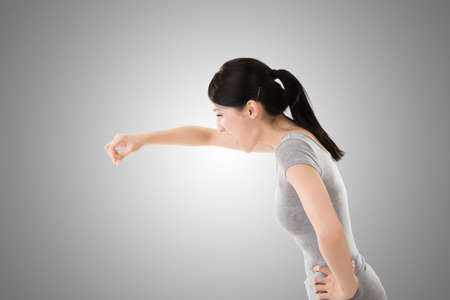 pose of Asian young woman holding or pointing something