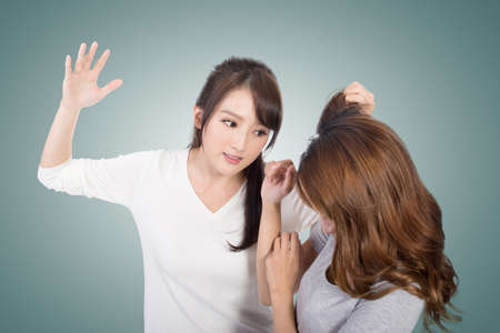Asian women fight and pull hair.の写真素材