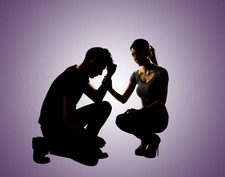 Silhouette of one sad Asian man squat and his wife give comfort to him, full length portrait isolatedの写真素材