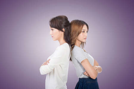 Unhappy Asian woman with her friend, closeup.の写真素材