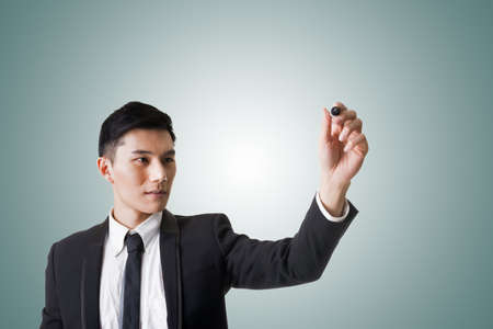Asian businessman writing or drawing.の写真素材